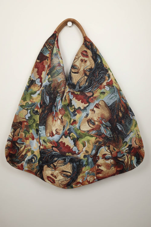 bolso yolykke en tejido y asas de piel estampado con caras de colores